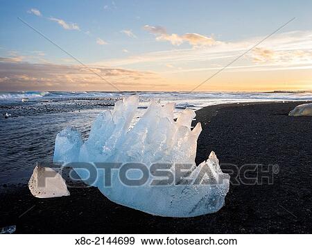 Stock Photo - Iceberg on black vulcanic beach. North Atlantic beach of the ice lagoon Joekulsarlon at glacier Breithamerkurjoekull, Vatnajoekull NP. europe, northern europe, iceland, march.. Fotosearch