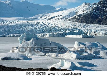 Stock Photography - Icebergs in frozen lagoon from the Fjallarlon glacier, iceland.. Fotosearch