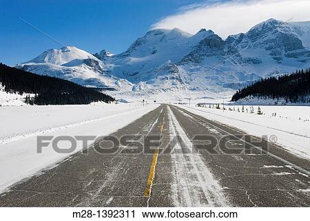 Stock Image - Icefields Parkway in winter, Mount Athabasca is in the distance, Jasper National Park Alberta Canada. Fotosearch