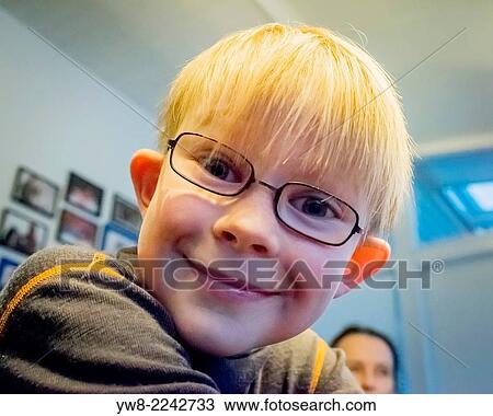 Stock Image - Icelandic 8 year old blond boy wearing glasses. Iceland.. Fotosearch