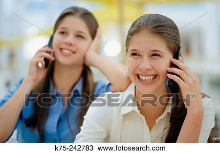 Identical twins on the phone View Large Photo Image Stock Image - Identical twins on the phone. Fotosearch