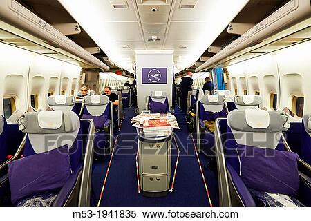Stock Photography - Iinterior view of the lower deck of an Airbus A380 jet airliner owned by the german airlines Lufthansa. Passengers are just boarding and finding their seats. Frankfurt International Airport. Germany.. Fotosearch