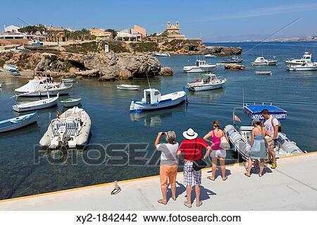 Illa de Tabarca Tabarca Island Alicante Province, Costa Blanca, Spain Tourists looking across the harbour to the town and church View Large Photo Image Stock Image - Illa de Tabarca Tabarca Island Alicante Province, Costa Blanca, Spain Tourists looking across the harbour to the town and church. Fotosearch