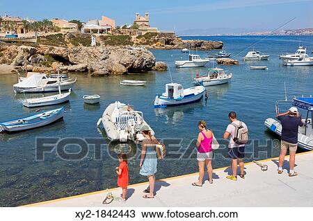 Illa de Tabarca Tabarca Island Alicante Province, Costa Blanca, Spain Tourists looking across the harbour to the town and church View Large Photo Image Stock Image - Illa de Tabarca Tabarca Island Alicante Province, Costa Blanca, Spain Tourists looking across the harbour to the town and church. Fotosearch