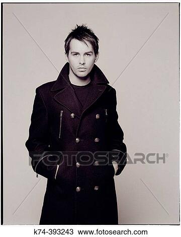 Image of man in long coat View Large Photo Image Stock Image - Image of man in long coat. Fotosearch