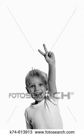 image of young boy making a peace sign with his fingers View Large Photo Image Stock Image - image of young boy making a peace sign with his fingers. Fotosearch