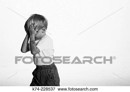 Stock Photo - image of young boy with hands over face. Fotosearch