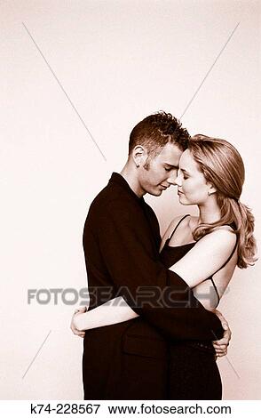 image of young couple embracing View Large Photo Image Stock Photo - image of young couple embracing. Fotosearch