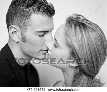 Stock Image - image of young couple kissing. Fotosearch