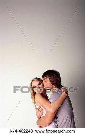 Stock Photo - image of young couple kissing. Fotosearch
