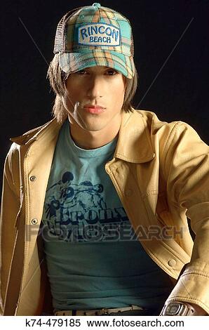 image of young man in leather jacket and baseball cap View Large Photo Image Stock Photography - image of young man in leather jacket and baseball cap. Fotosearch