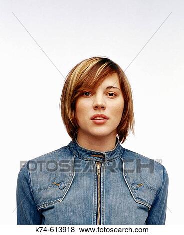 Stock Photo - image of young woman in denim jacket looking at viewer. Fotosearch