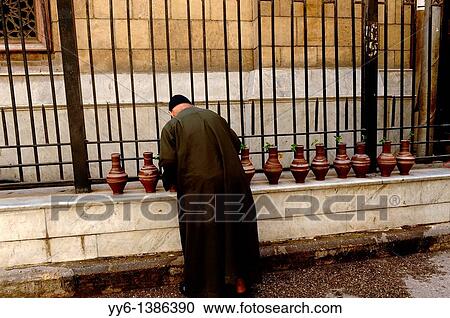 imam filling up water bottles, outside the Al-Hussein Mosque, which sits on the site of the cemetery of the Fatimid caliphs, islamic cairo, cairo, egypt View Large Photo Image Stock Image - imam filling up water bottles, outside the Al-Hussein Mosque, which sits on the site of the cemetery of the Fatimid caliphs, islamic cairo, cairo, egypt. Fotosearch