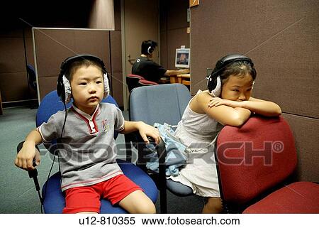 Stock Photography - In library children watching movie.. Fotosearch