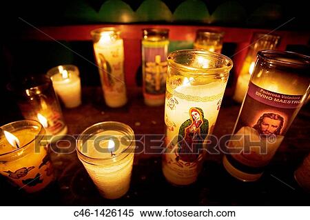 Stock Photography - In Santo Tomas Church worshippers are burning candles to their ancestors and to the saints Rose petals are used to invoke blessings for children, safe travel, marriage or to cure illness Chichicastenango Guatemala. Fotosearch