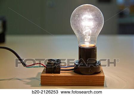 Stock Image - Incandescent lamp. Laboratory tests. Manufacture of electrical equipment.. Fotosearch