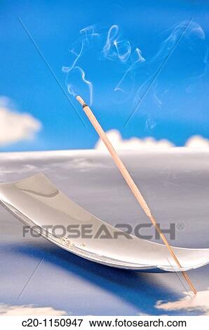 Incense stick burning on a background of blue sky and white clouds View Large Photo Image Stock Photo - Incense stick burning on a background of blue sky and white clouds. Fotosearch