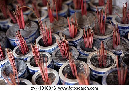 Stock Photograph - Incense sticks burning at the Hoa Lu temple near Ninh Binh in northern Vietnam. Fotosearch
