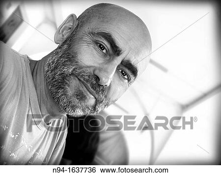 Inclined bald man, young, handsome with a beard. View Large Photo Image Stock Photograph - Inclined bald man, young, handsome with a beard.. Fotosearch