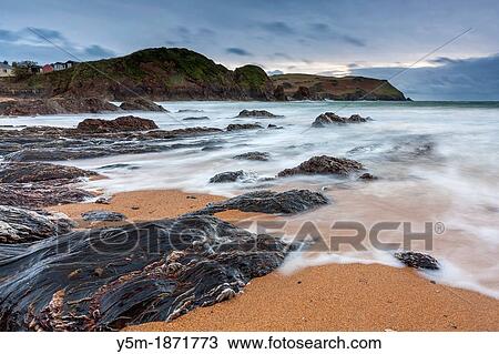 Stock Image - Incoming waves om beach, Hope Cove, South Hams, Devon, England, United Kingdom, Europe. Fotosearch