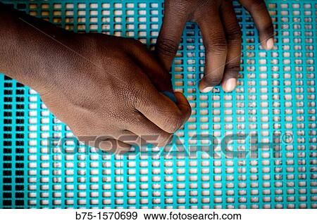 Stock Photo - India, Mundog, Blind Hospital, woman writing Braille. Fotosearch