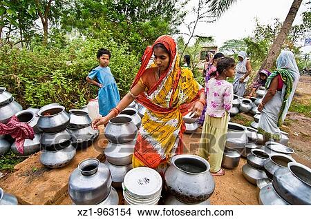 Picture - India, Orissa, way to Padmapur village, water distribution. Fotosearch