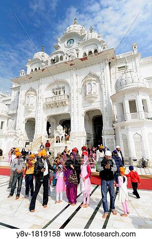 India. Punjab. Amritsar. The Golden Temple. The Parikrama Marble Path where Sikh believers pray, and the Ghanta Ghar Deohdi Gate of Victorian style. View Large Photo Image Stock Photo - India. Punjab. Amritsar. The Golden Temple. The Parikrama Marble Path where Sikh believers pray, and the Ghanta Ghar Deohdi Gate of Victorian style.. Fotosearch