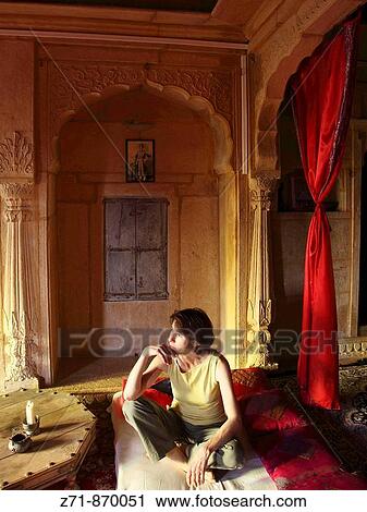 Stock Image - India, Rajasthan, Jaisalmer, Shreenath Palace Hotel, room, western tourist. Fotosearch