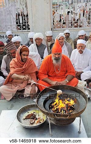 Stock Photo - India, Rajasthan, Mukam, Jambeshwar festival, Bishnoi priests performing a Havan or holy fire.. Fotosearch