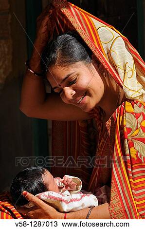 India, Rajasthan, Shekhawati, Mandawa, Young mother with her newborn baby View Large Photo Image Stock Image - India, Rajasthan, Shekhawati, Mandawa, Young mother with her newborn baby. Fotosearch