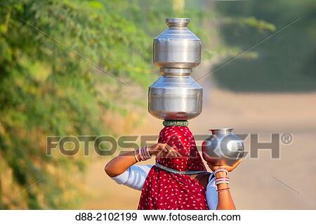 India, Rajasthan state, Bera area, indian woman carrying water on her head. View Large Photo Image Stock Photo - India, Rajasthan state, Bera area, indian woman carrying water on her head.. Fotosearch