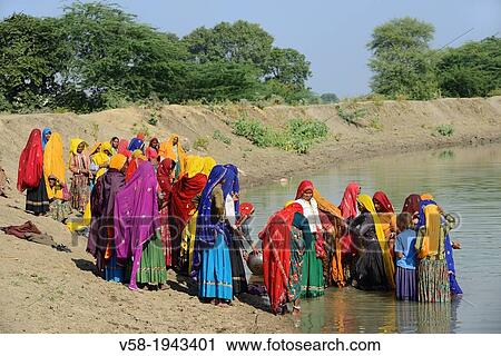 Stock Image - India, Rajasthan, Tonk region, Damun village, Women taking bath.. Fotosearch