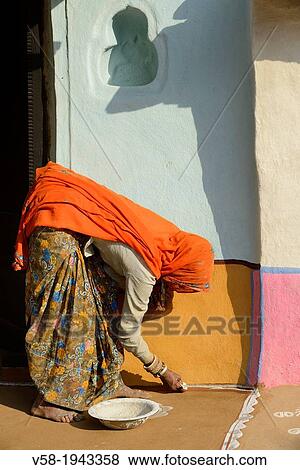 India, Rajasthan, Tonk region, Woman painting a floor Mandana with chalk powder. View Large Photo Image Stock Photo - India, Rajasthan, Tonk region, Woman painting a floor Mandana with chalk powder.. Fotosearch