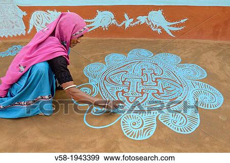 India, Rajasthan, Tonk region, Woman painting a geometrical floor mandana prior to Diwali festival. View Large Photo Image Stock Photo - India, Rajasthan, Tonk region, Woman painting a geometrical floor mandana prior to Diwali festival.. Fotosearch