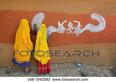 India, Rajasthan, Tonk region, Women painting clay walls prior to Diwali festival. View Large Photo Image Stock Image - India, Rajasthan, Tonk region, Women painting clay walls prior to Diwali festival.. Fotosearch