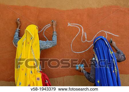 India, Rajasthan, Tonk region, Women painting clay walls prior to Diwali festival. View Large Photo Image Stock Photo - India, Rajasthan, Tonk region, Women painting clay walls prior to Diwali festival.. Fotosearch