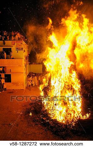 Stock Image - India, Uttar Pradesh, Holi festival, colour and spring festival celebrating the love between Krishna and Radha, Holika Dahan: the Holi bonfire.. Fotosearch