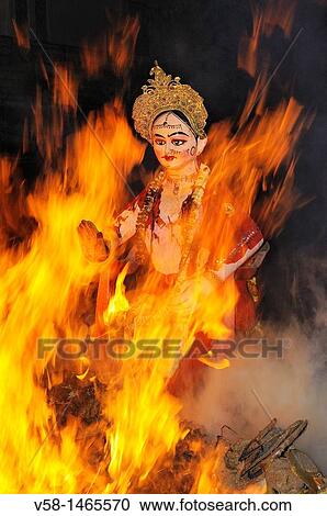 Stock Image - India, Uttar Pradesh, Holi festival, Colour and spring festival celebrating the love between Krishna and Radha, Holika Dahan: The Holi bonfire. Fotosearch