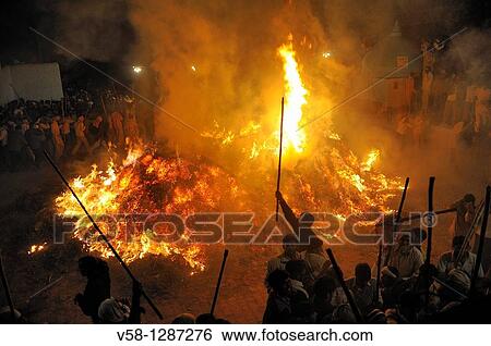 India, Uttar Pradesh, Holi festival, colour and spring festival celebrating the love between Krishna and Radha, cheerful crowd around Holika Dahan, the Holi bonfire View Large Photo Image Stock Photograph - India, Uttar Pradesh, Holi festival, colour and spring festival celebrating the love between Krishna and Radha, cheerful crowd around Holika Dahan, the Holi bonfire. Fotosearch