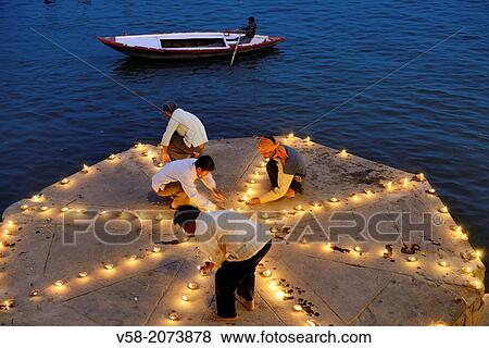 India, Uttar Pradesh, Varanasi, Dev Deepawali festival, Hindu devotees lighting oil lamps. View Large Photo Image Stock Photo - India, Uttar Pradesh, Varanasi, Dev Deepawali festival, Hindu devotees lighting oil lamps.. Fotosearch