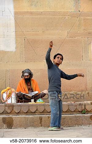 India, Uttar Pradesh, Varanasi, Sadhu (ascetic) and young boy flying a kite. View Large Photo Image Stock Photograph - India, Uttar Pradesh, Varanasi, Sadhu (ascetic) and young boy flying a kite.. Fotosearch