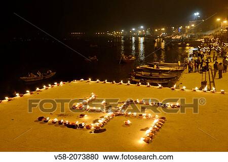 India, Uttar Pradesh, Varanasi, Swastika shaped earthen lamps lit for Dev Deepawali festival. View Large Photo Image Stock Image - India, Uttar Pradesh, Varanasi, Swastika shaped earthen lamps lit for Dev Deepawali festival.. Fotosearch
