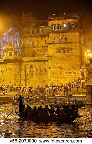 Stock Image - India, Uttar Pradesh, Varanasi, Boatride along the ghats during Dev Deepawali festival.. Fotosearch