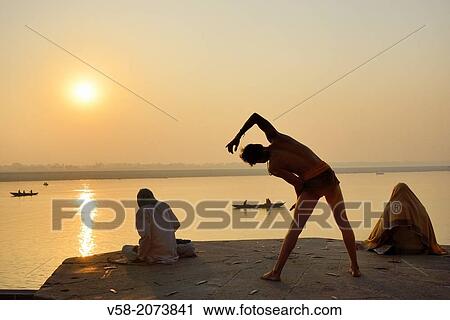 India, Uttar Pradesh, Varanasi, Yogi practising at sunrise. View Large Photo Image Stock Image - India, Uttar Pradesh, Varanasi, Yogi practising at sunrise.. Fotosearch