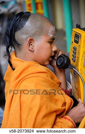 Picture - India, Uttar Pradesh, Varanasi, Young Brahmin making a phone call.. Fotosearch