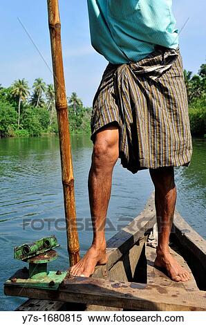 Indian boatman with bamboo pole rowing, close-up, Kerala backwaters, Kerala, South India, Asia View Large Photo Image Stock Photography - Indian boatman with bamboo pole rowing, close-up, Kerala backwaters, Kerala, South India, Asia. Fotosearch