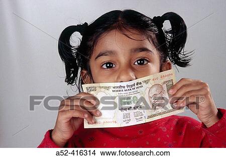 Indian girl child with Rupees five hundred bank note. View Large Photo Image Picture - Indian girl child with Rupees five hundred bank note.. Fotosearch