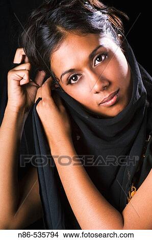Indian girl fixing her veil View Large Photo Image Picture - Indian girl fixing her veil. Fotosearch