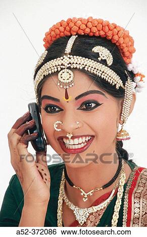 Stock Photograph - Indian lady with cell phone. Fotosearch