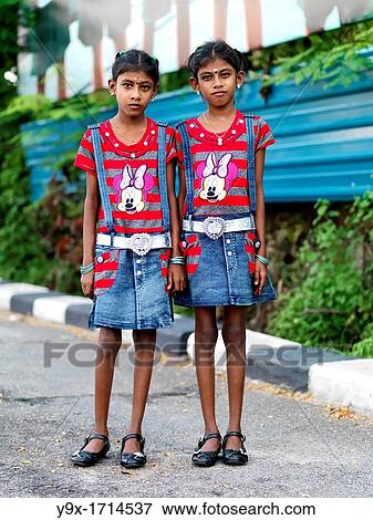 Stock Photo - Indian Malaysian twins dressed in identical clothing. Fotosearch